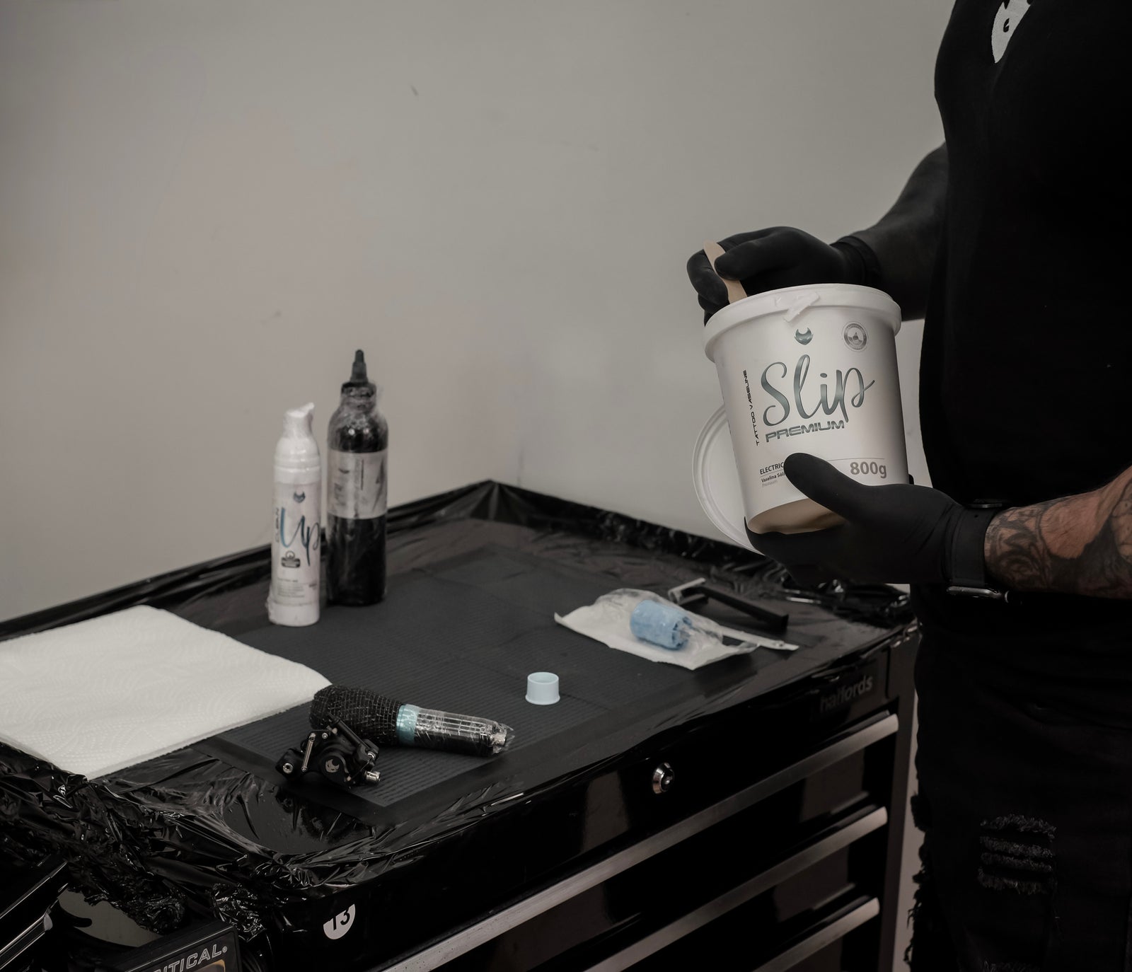 An Ink Society tattoo workstation prepared with protective barriers and organised equipment.